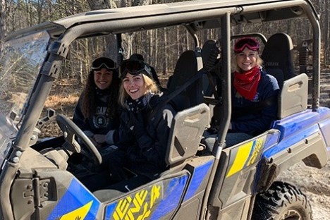 a group of people riding on the back of a motorcycle