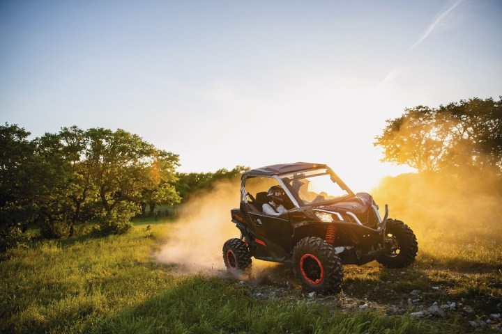 a car driving down a dirt road