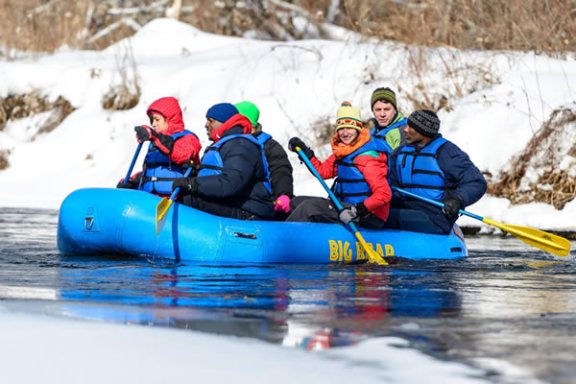 a group of people riding skis across snow covered ground