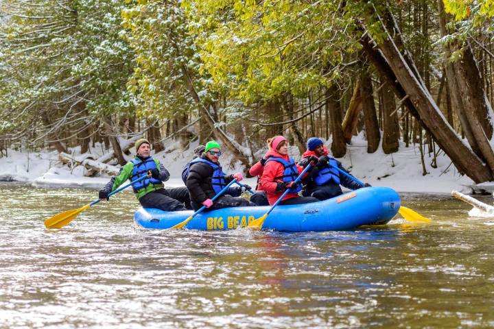 a group of people riding skis on a raft