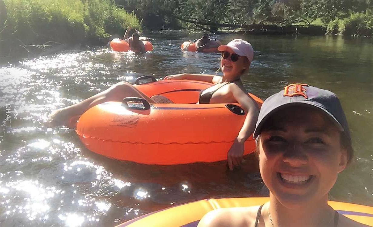 a person standing in front of a boat next to a body of water