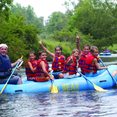 a group of people riding on a raft in a body of water