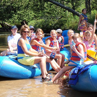 a group of people on a raft in a pool of water